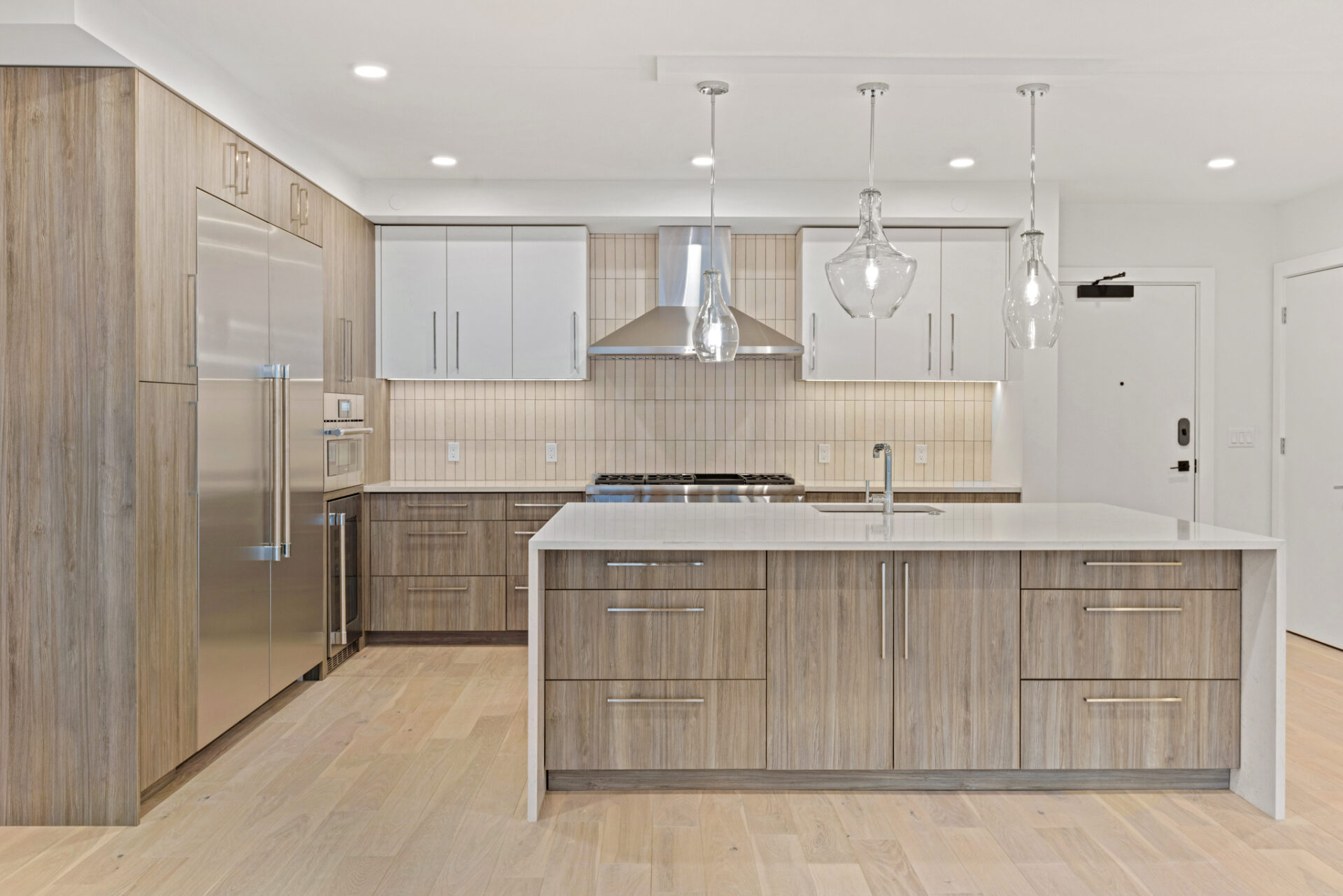 Finish Package A kitchen at The Henry featuring light cabinetry and quartz countertops